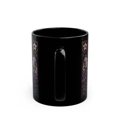 Black mug with stained glass style floral pattern on sides.
