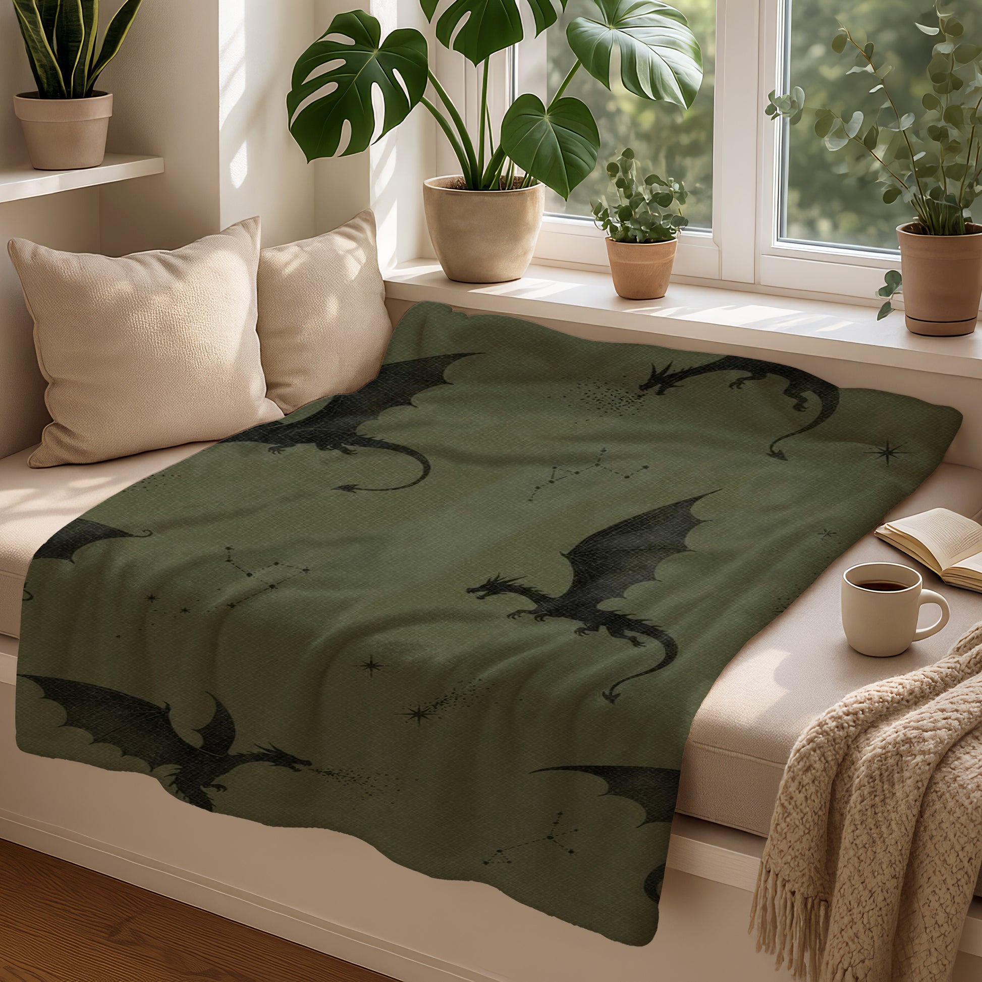 Green blanket with black dragon print and constellations on a window seat
