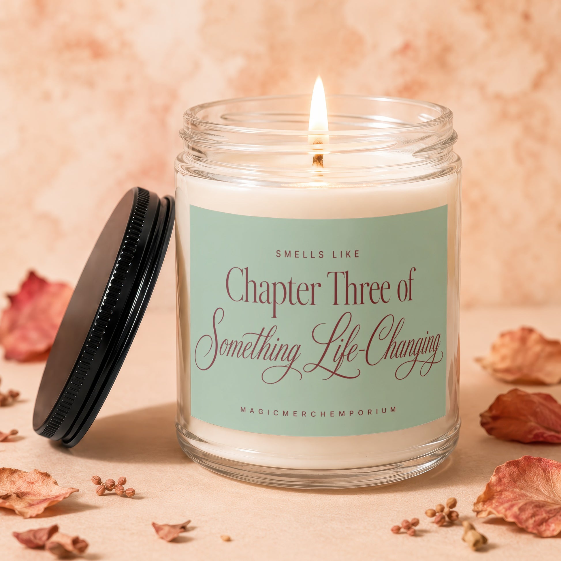 Lit candle with "Chapter Three of Something Life-Changing" text on pale green label.