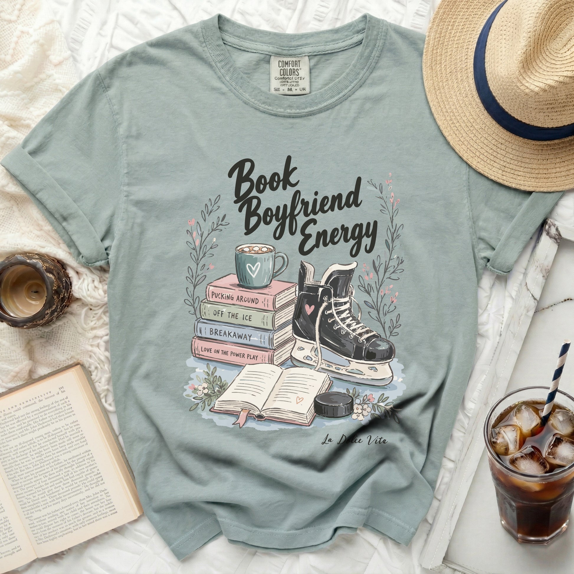 Shirt with "Book Boyfriend Energy" text, ice skates, and book stack.