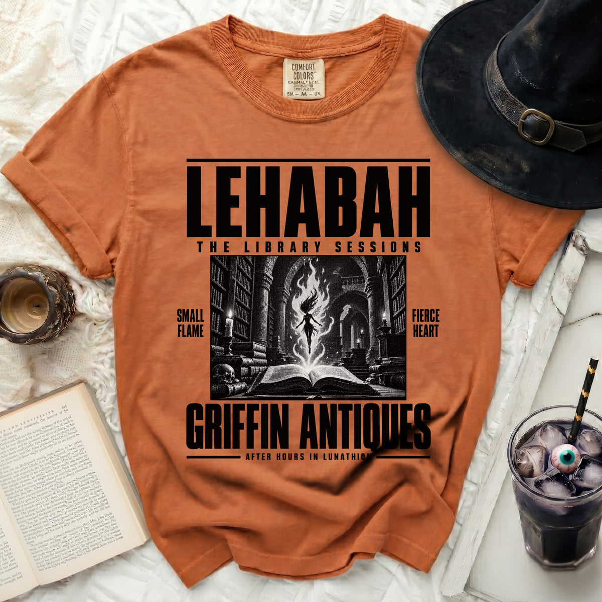 Orange t-shirt with "LEHABAH THE LIBRARY SESSIONS GRIFFIN ANTIQUES" text.