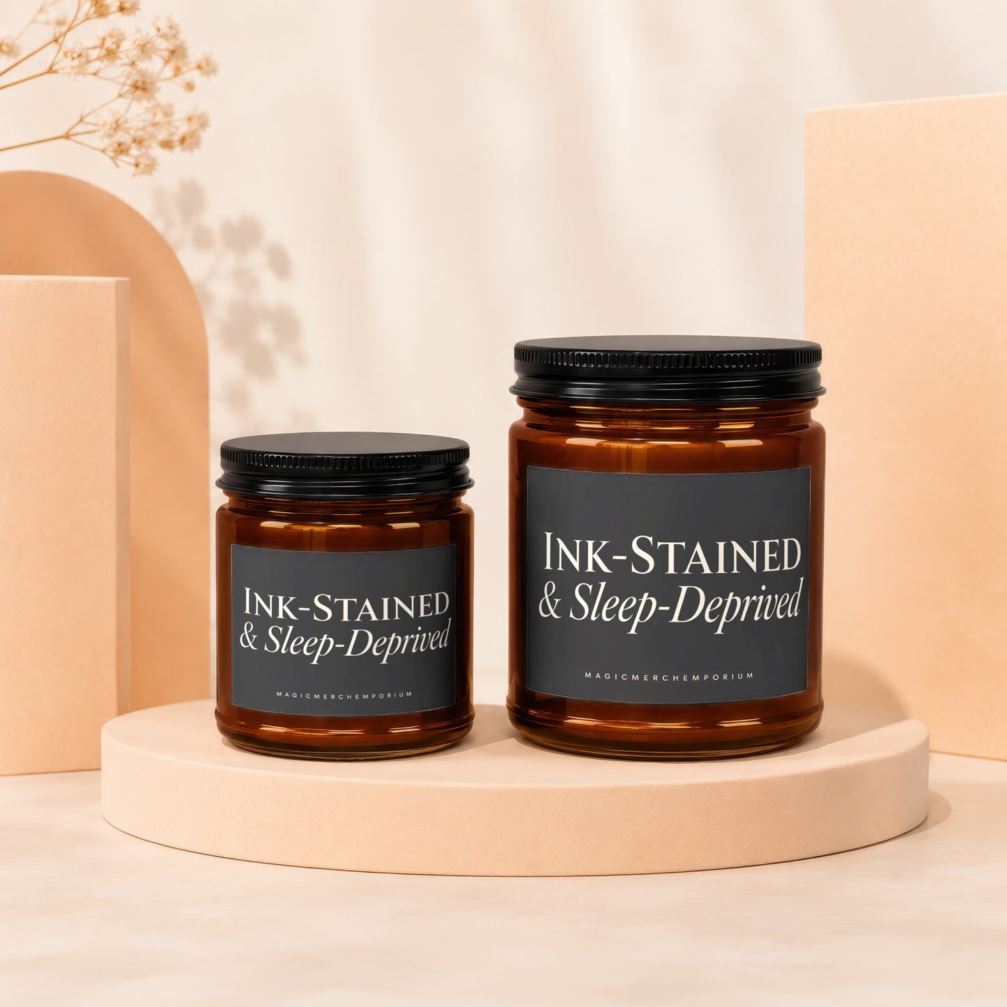 Two amber glass jars with black lids, "INK-STAINED & Sleep-Deprived" text.