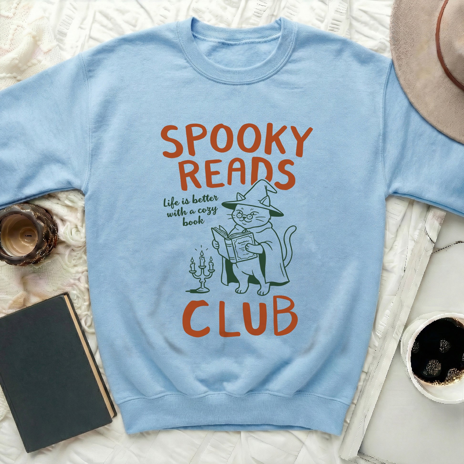 Light blue sweatshirt with "Spooky Reads Club" text and cat reading a book.