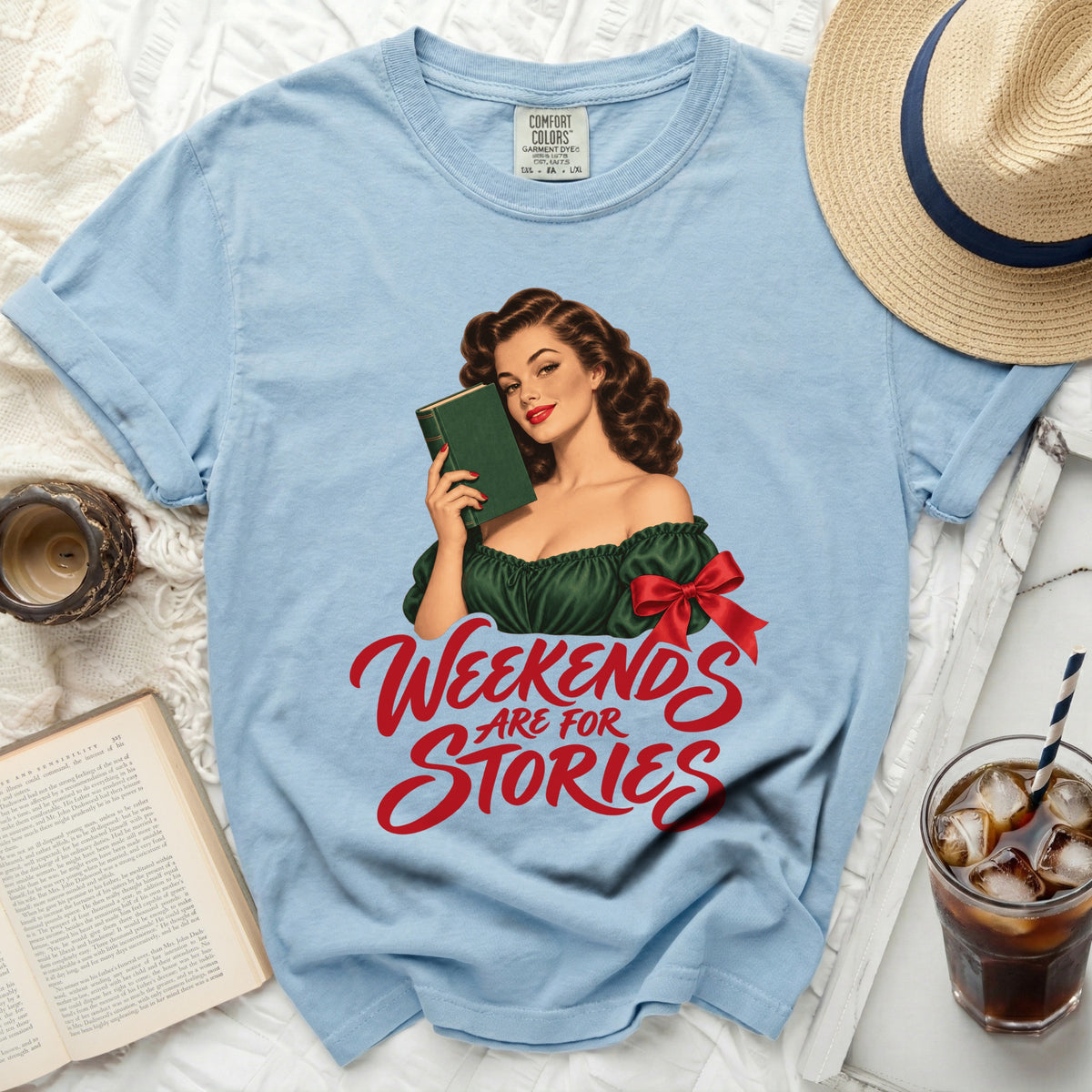 Light blue t-shirt with vintage pin-up girl holding a book and text "Weekends Are For Stories".