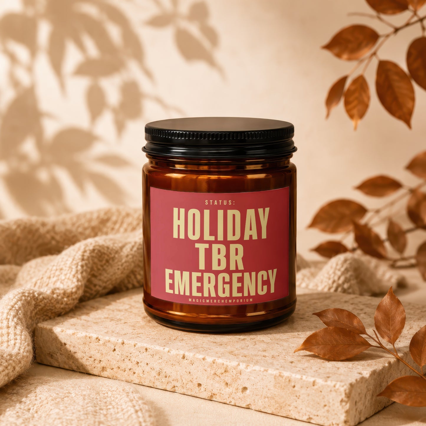 Amber candle with red label reading "Holiday TBR Emergency".