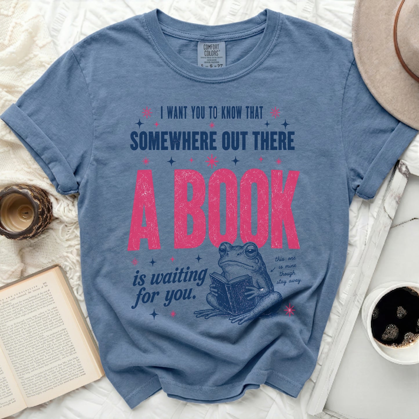 Blue t-shirt with frog reading book and inspirational text.