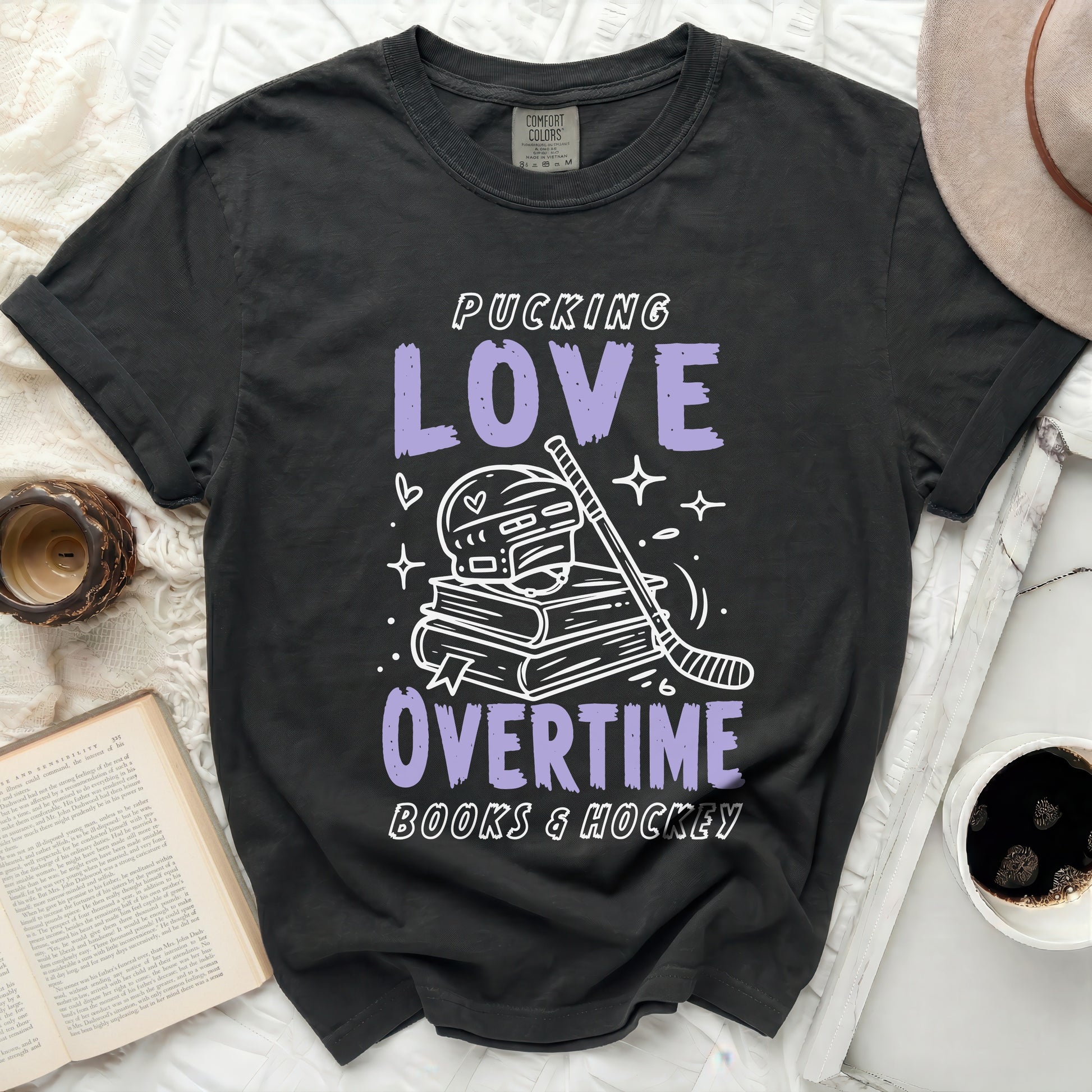 Dark t-shirt with "Pucking Love Overtime Books & Hockey" text and hockey graphics.