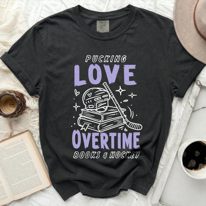 Dark t-shirt with "Pucking Love Overtime Books & Hockey" text and hockey graphics.