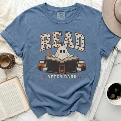 Blue t-shirt featuring a ghostly illustration reading a book with the text Read After Dark.