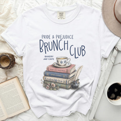 White t-shirt with "Pride & Prejudice Brunch Club" graphic and stack of books.