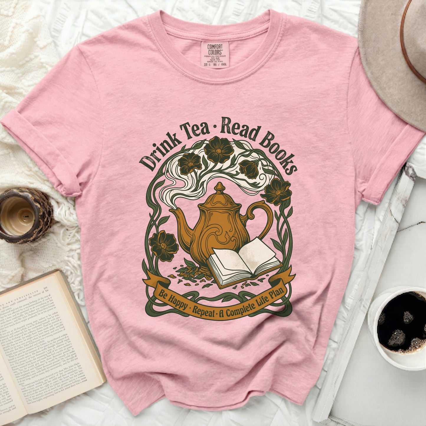 Pink t-shirt with "Drink Tea Read Books" and teapot illustration.