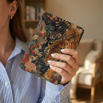 Woman holds a case with a tiger and floral design.