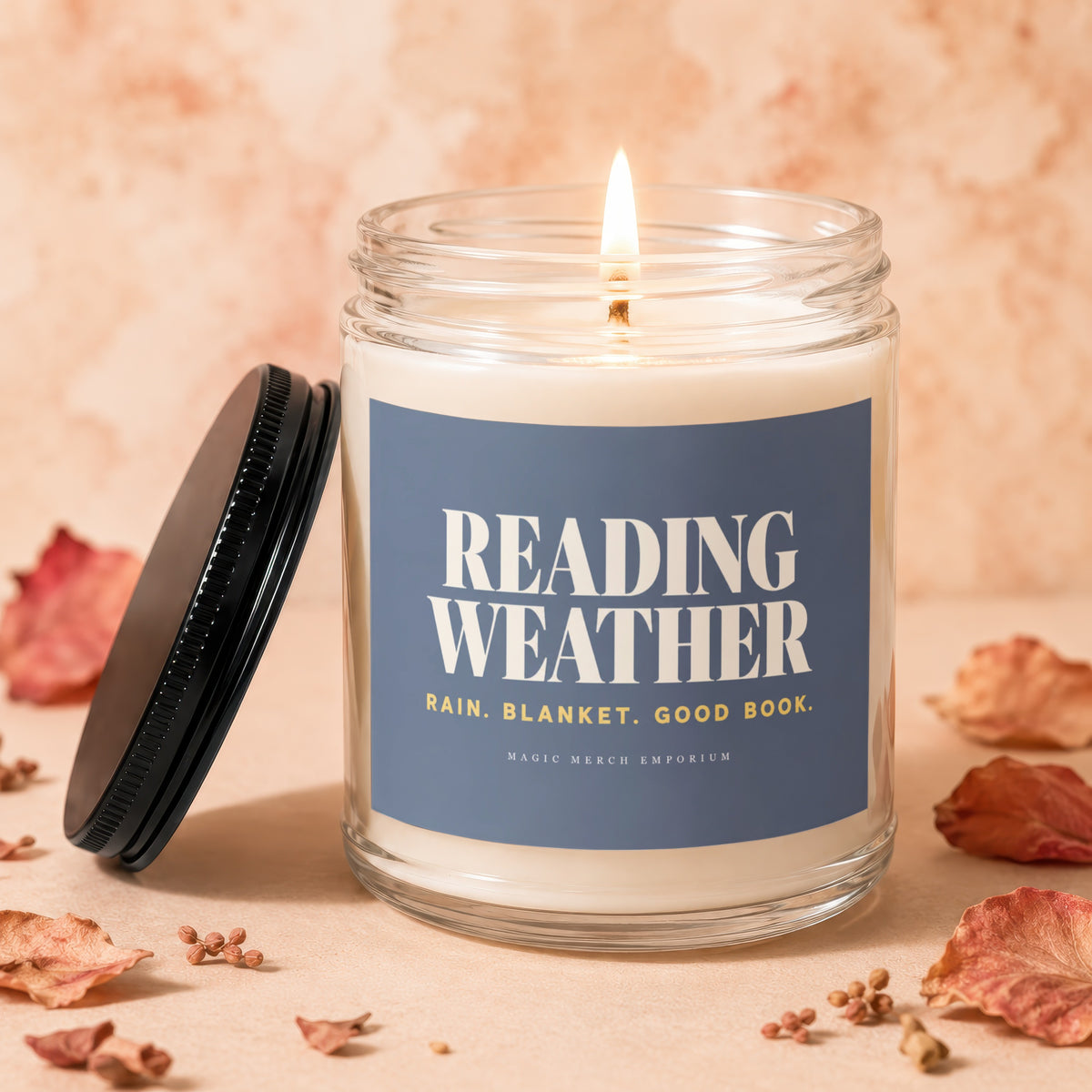 Glass jar candle with "Reading Weather" text, lit flame.