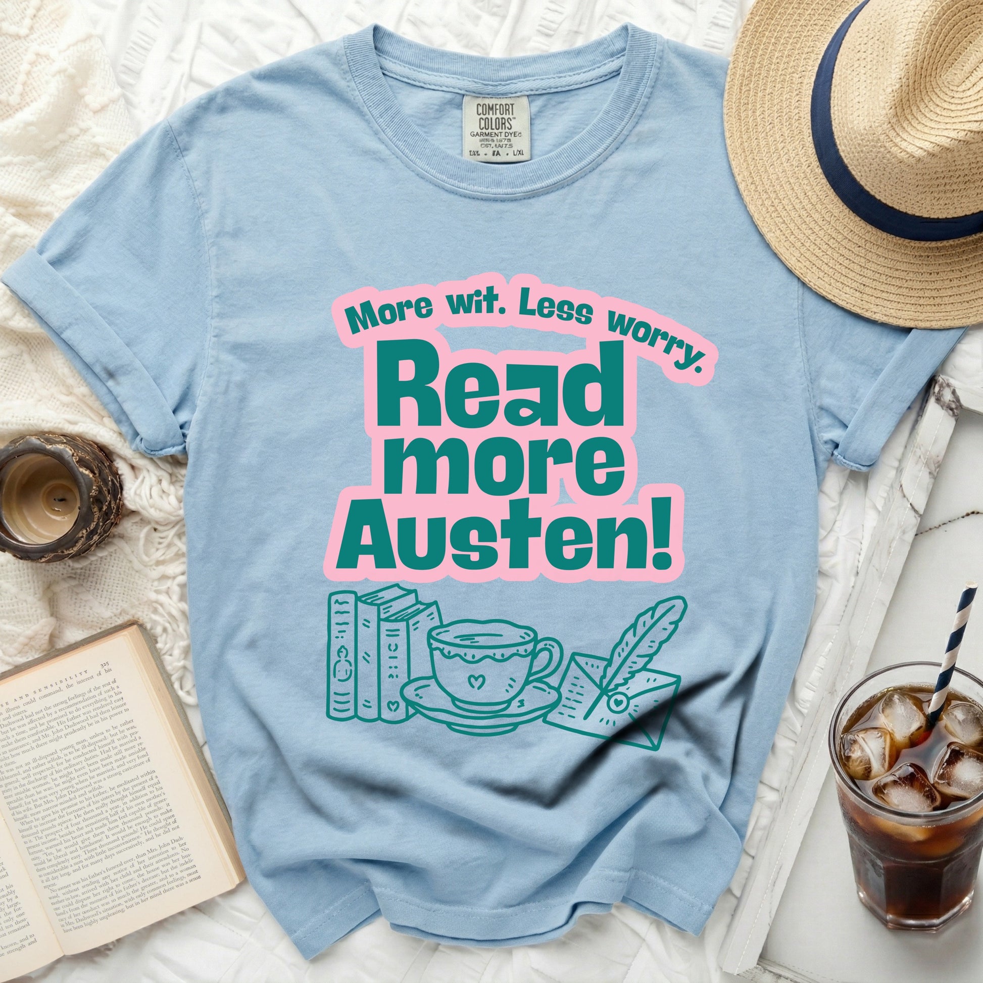 Light blue Comfort Colors t-shirt with "More wit. Less worry. Read more Austen!" graphic.