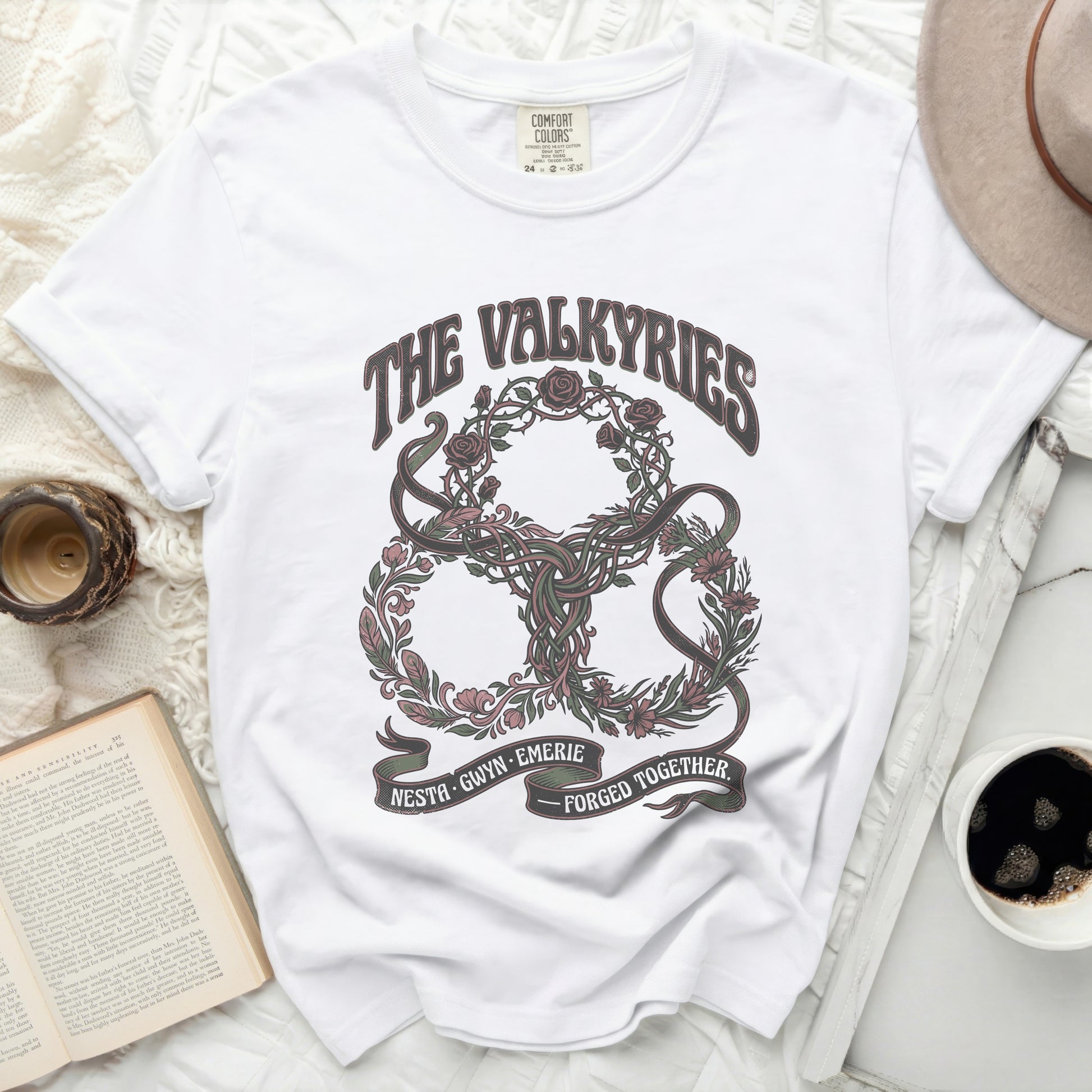 White t-shirt with "The Valkyries" and floral knot design.
