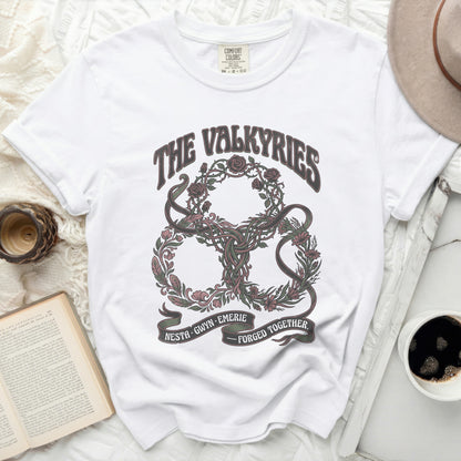 White t-shirt with "The Valkyries" and floral knot design.
