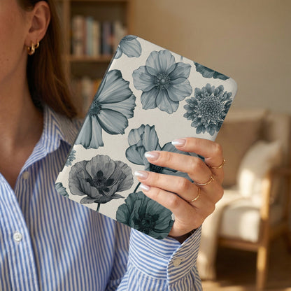 Device with a blue floral pattern held by a person in a striped blue shirt.
