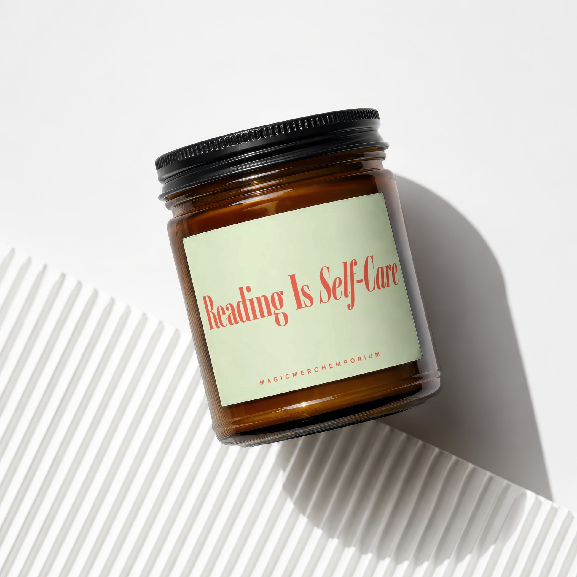 Amber jar candle with light green label reading "Reading Is Self-Care".