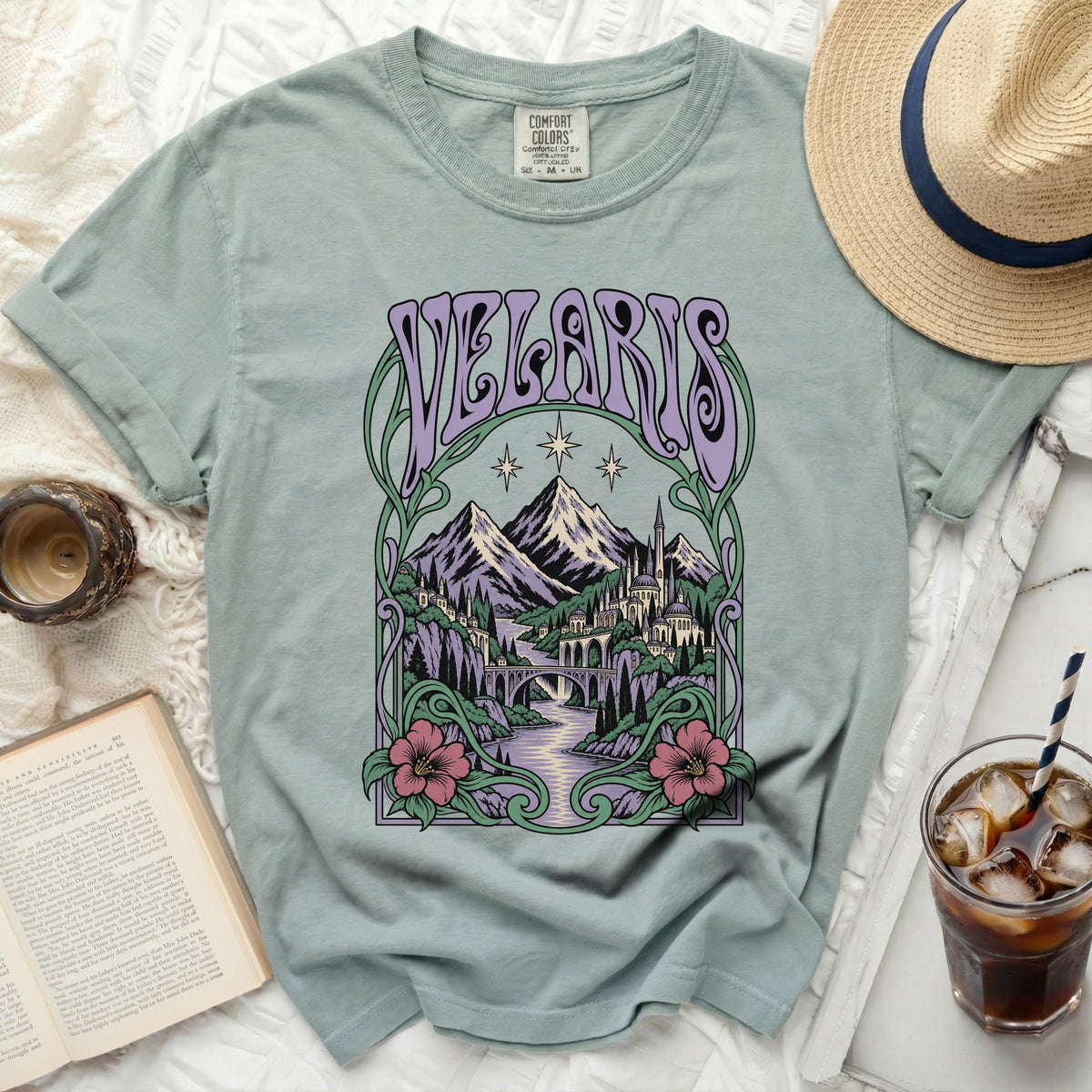 Light teal t-shirt with "VELARIS" text and a fantasy landscape design.