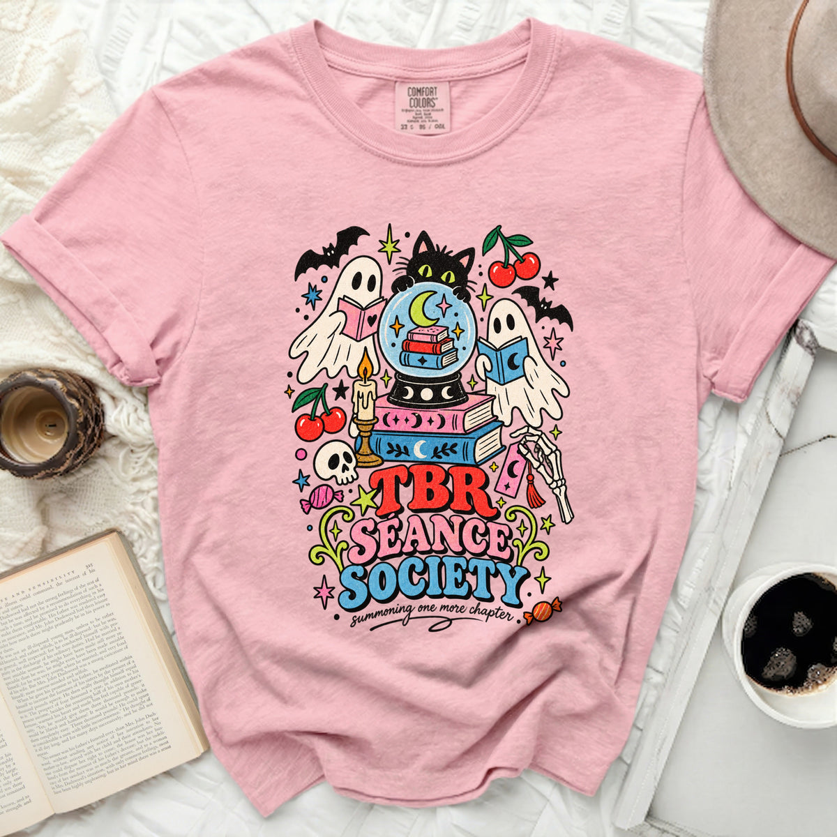 Pink t-shirt with "TBR Seance Society" graphic, featuring ghosts, a cat, and books.