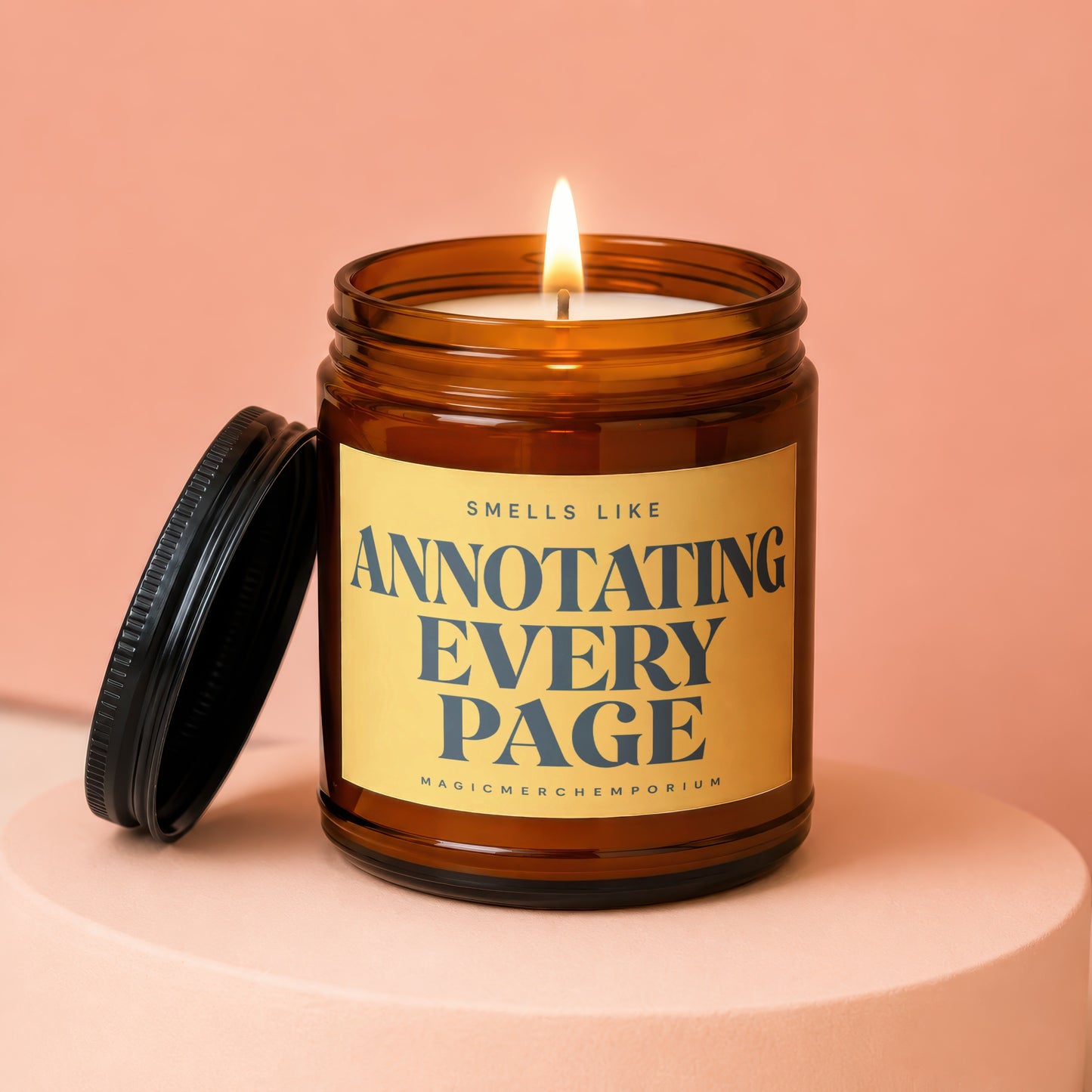 Amber jar candle with lit wick and black lid, reads "Smells Like Annotating Every Page".