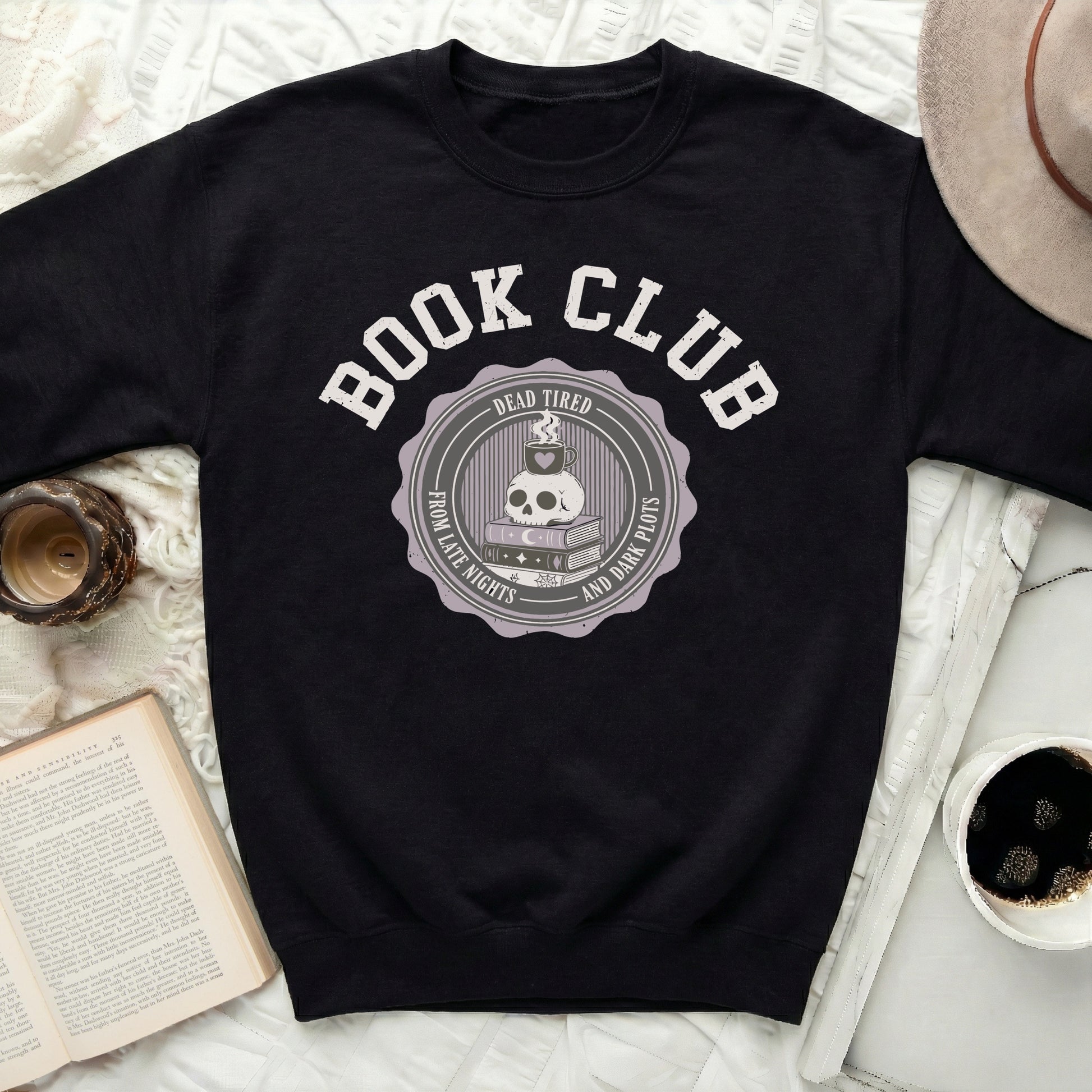 Black sweatshirt with "Book Club Dead Tired From Late Nights And Dark Plots" graphic.