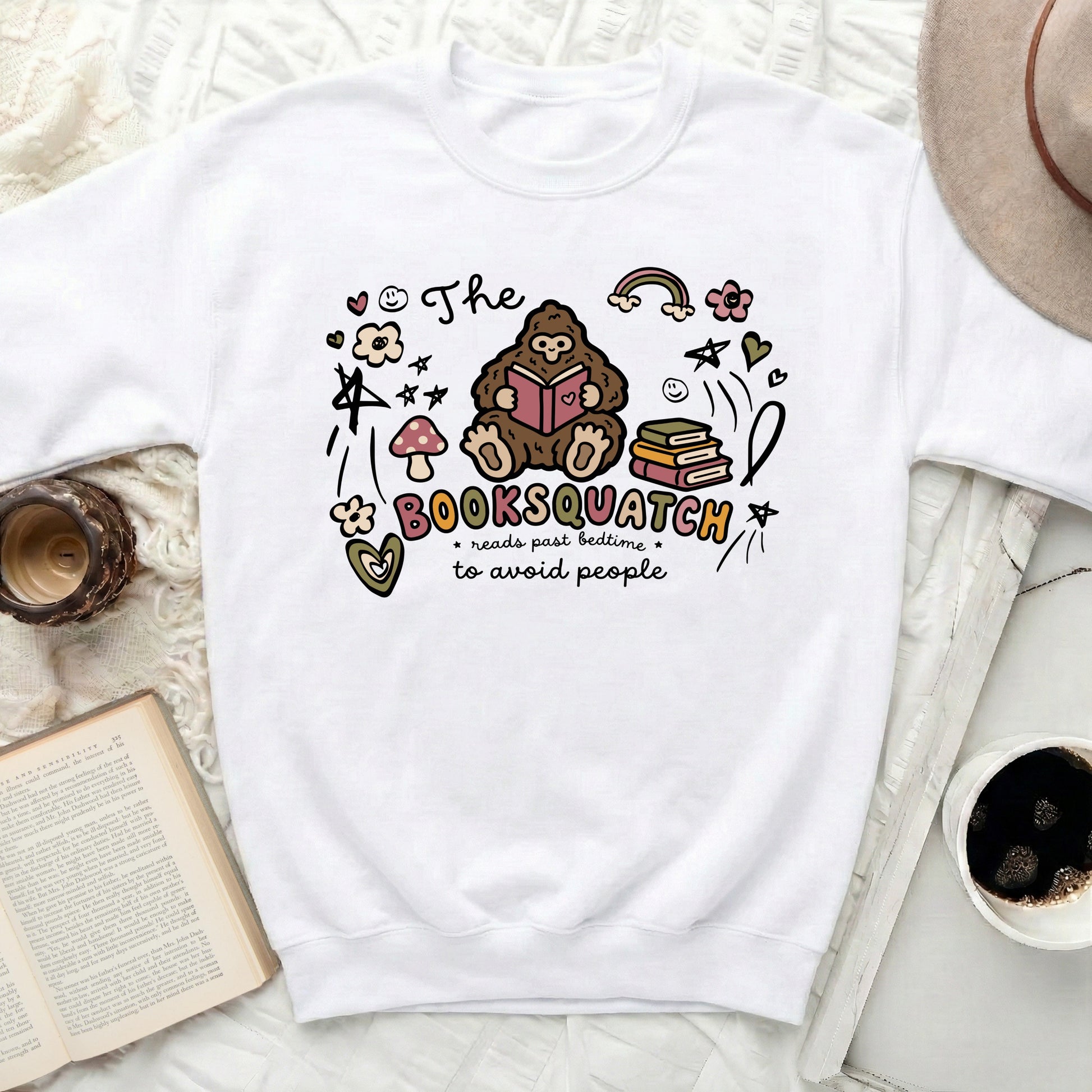 Booksquatch reads past bedtime to avoid people graphic on white sweatshirt.