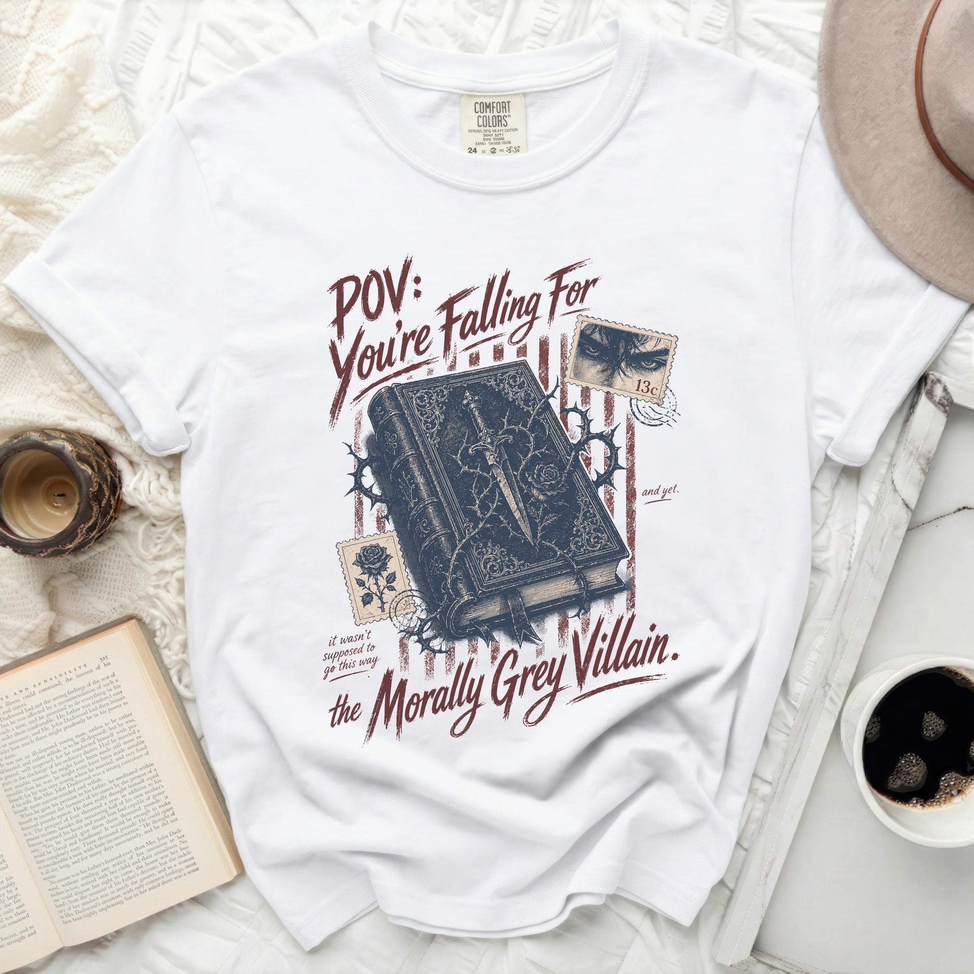 T-shirt with "POV: You're Falling For the Morally Grey Villain." text and book illustration.