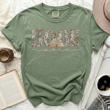 Comfort Colors t-shirt with floral "BOOK WORM" text and open book graphic.