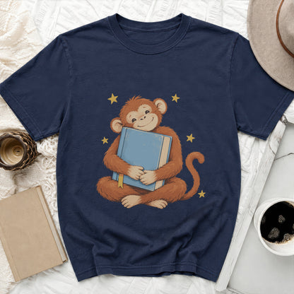 Navy t-shirt with cartoon monkey hugging a blue book and stars.