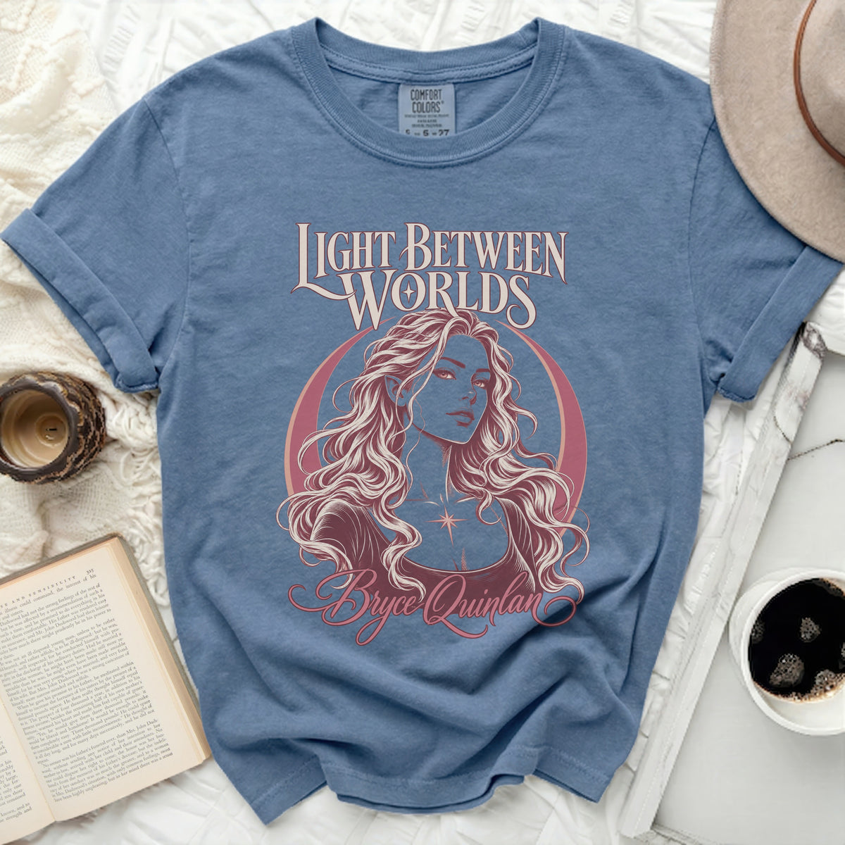 Blue t-shirt with "Light Between Worlds" and Bryce Quinlan graphic.