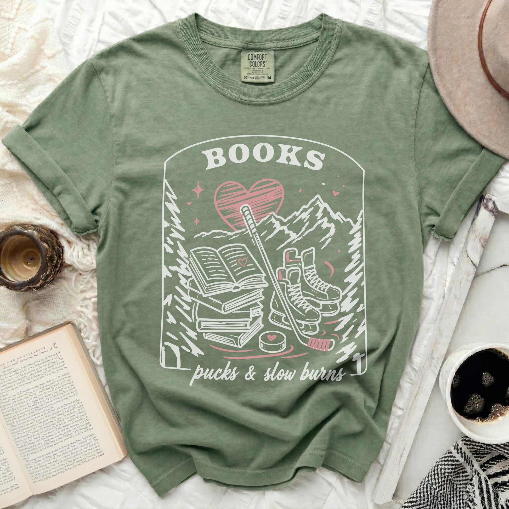 Green t-shirt with "Books, pucks & slow burns" text and hockey illustration.