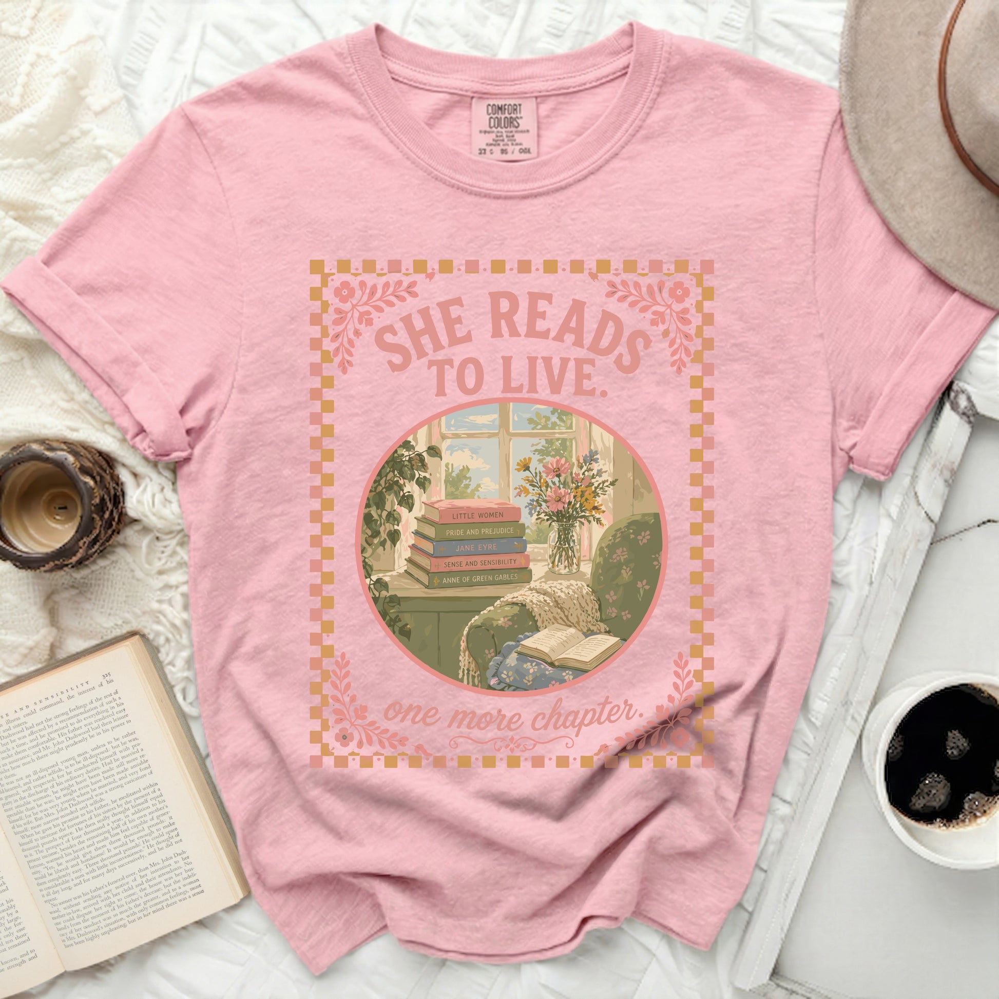 Pink t-shirt with "She Reads to Live" and books graphic.