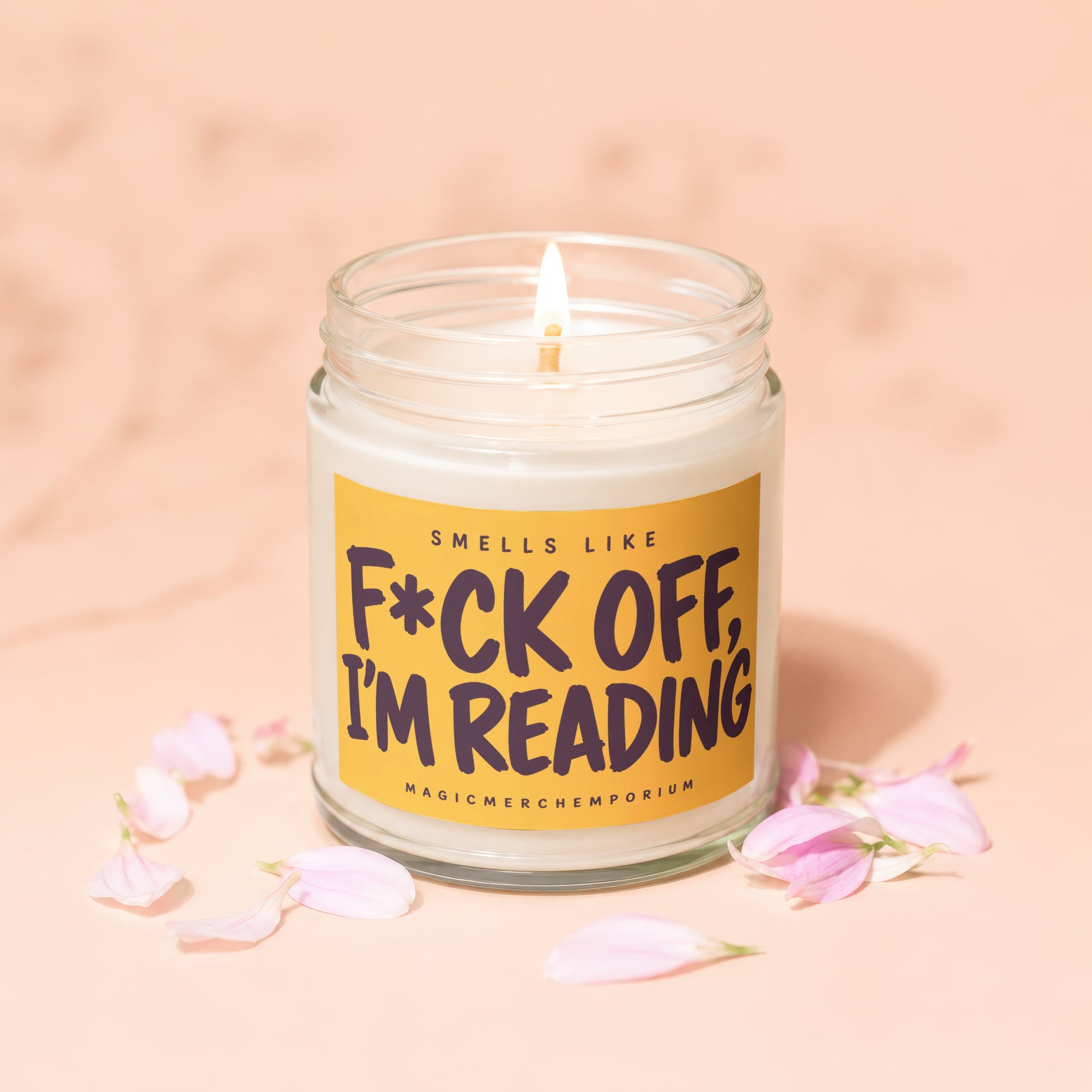 Candle with text "F*ck Off, I'm Reading" surrounded by pink petals.