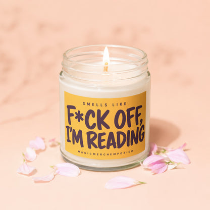Candle with text "F*ck Off, I'm Reading" surrounded by pink petals.
