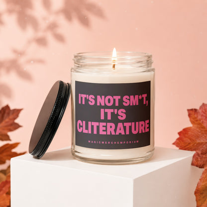 Glass candle with black lid, reading "IT'S NOT SM*T, IT'S CLITERATURE".