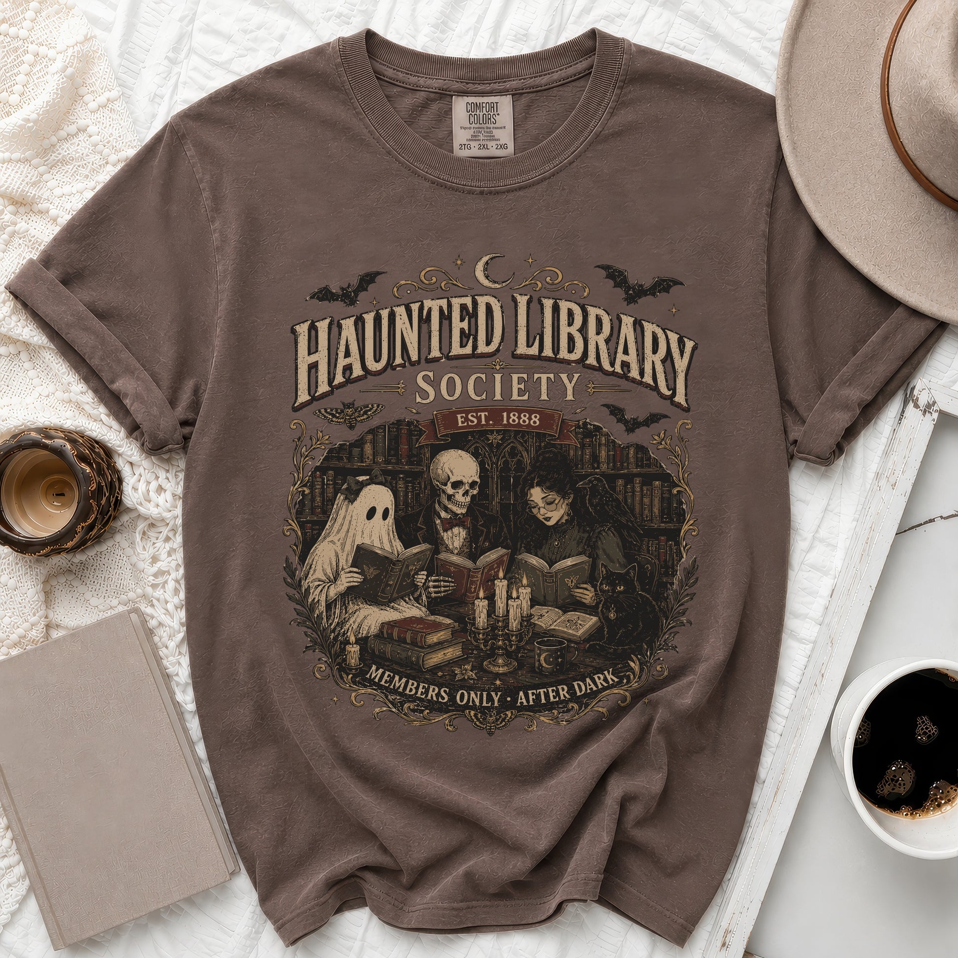 Brown t-shirt with "Haunted Library Society Est. 1888 Members Only After Dark" graphic.