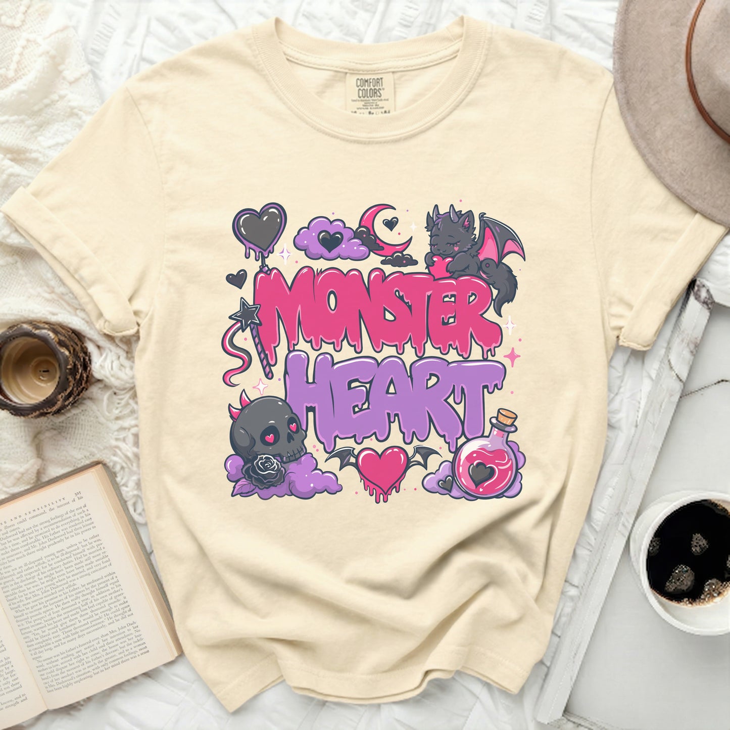 Cream t-shirt with "Monster Heart" graphic and gothic cartoon elements.