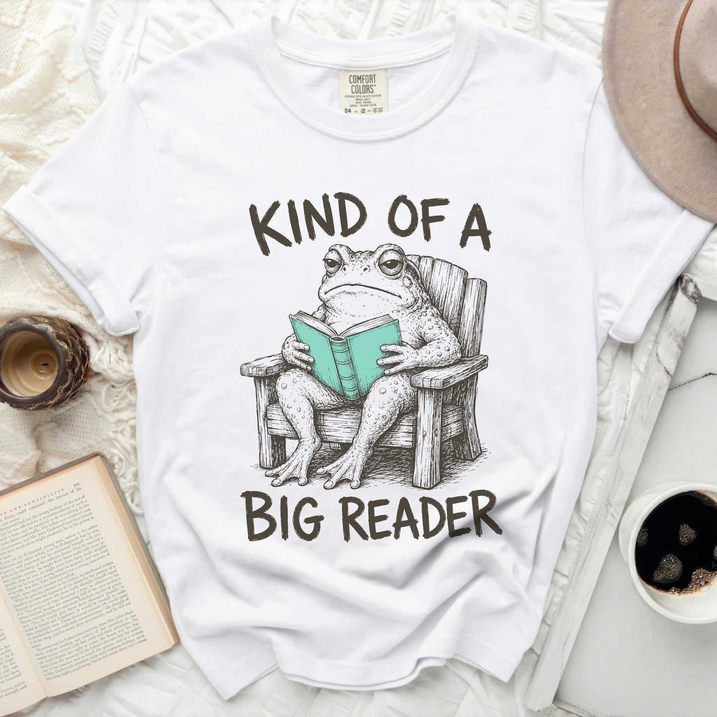 Toad in a chair reading a book with text "Kind of a Big Reader".