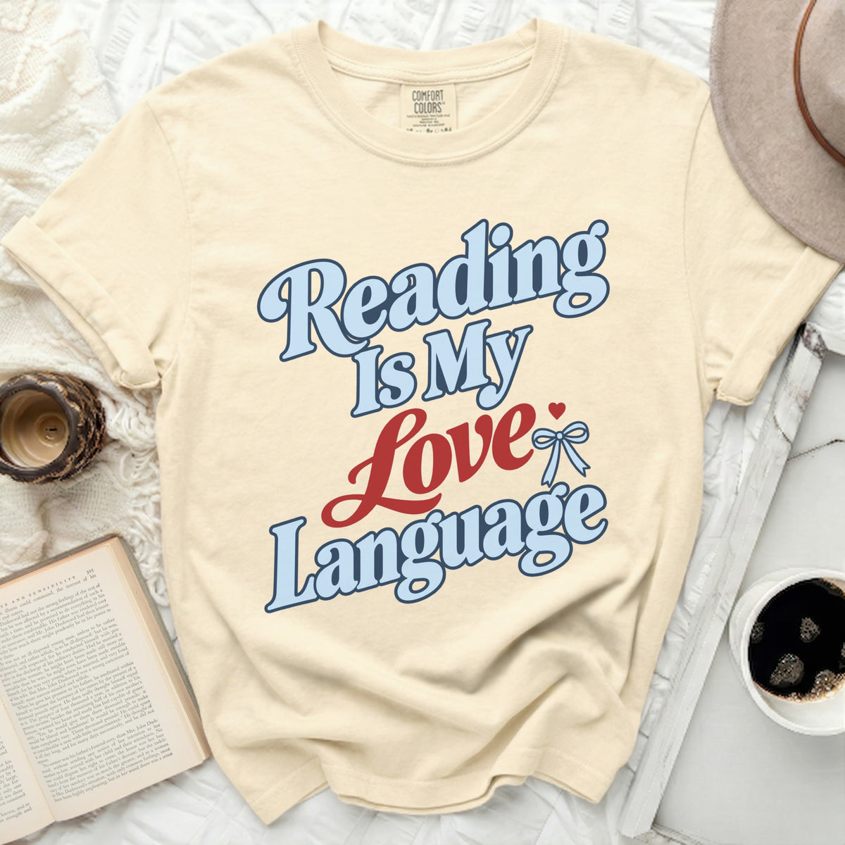 Cream t-shirt with "Reading Is My Love Language" text in blue and red.