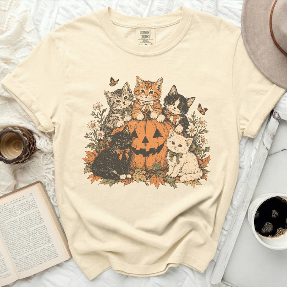 Cream t-shirt with five kittens and a pumpkin graphic with butterflies and flowers.