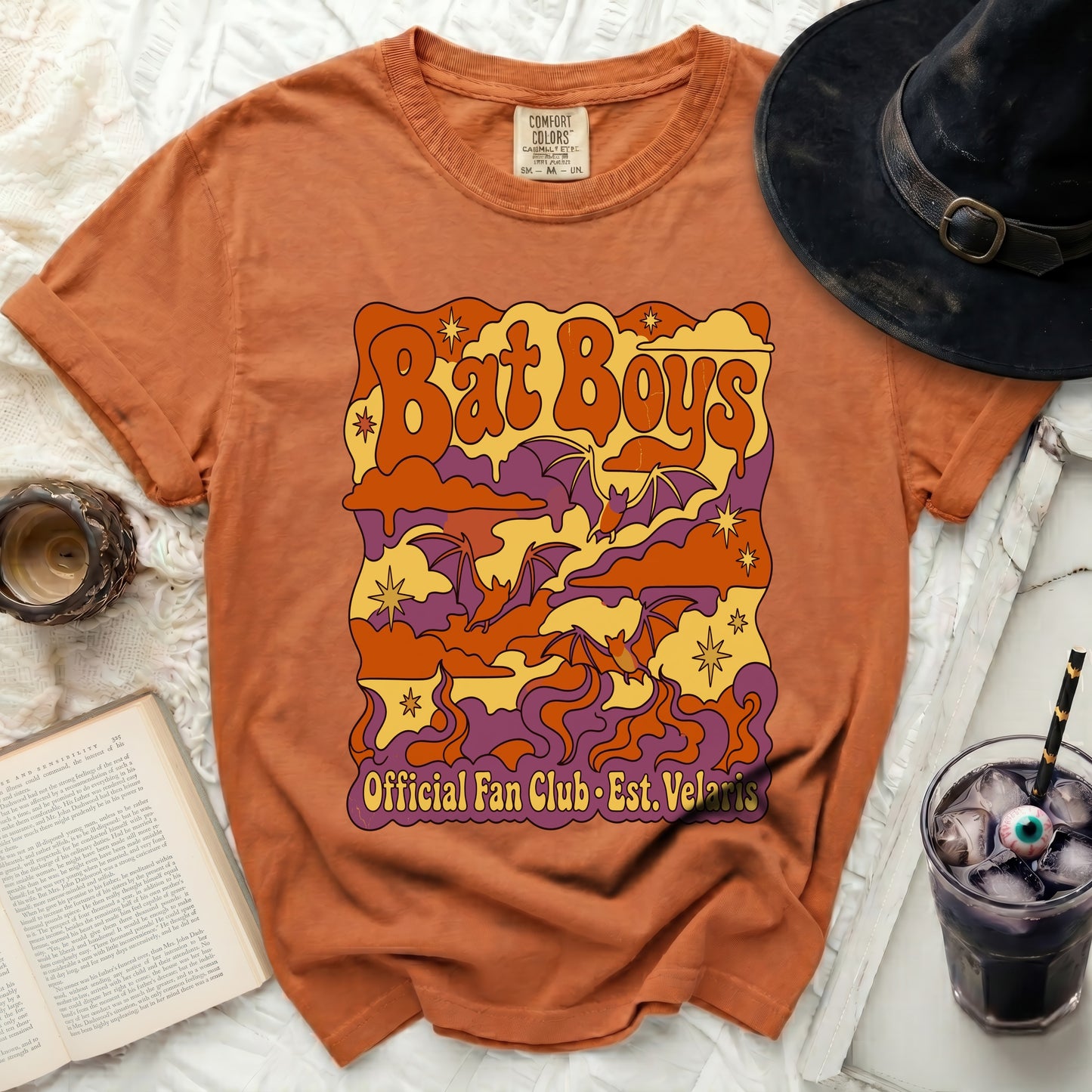 Orange t-shirt with "Bat Boys Official Fan Club Est. Velaris" graphic.