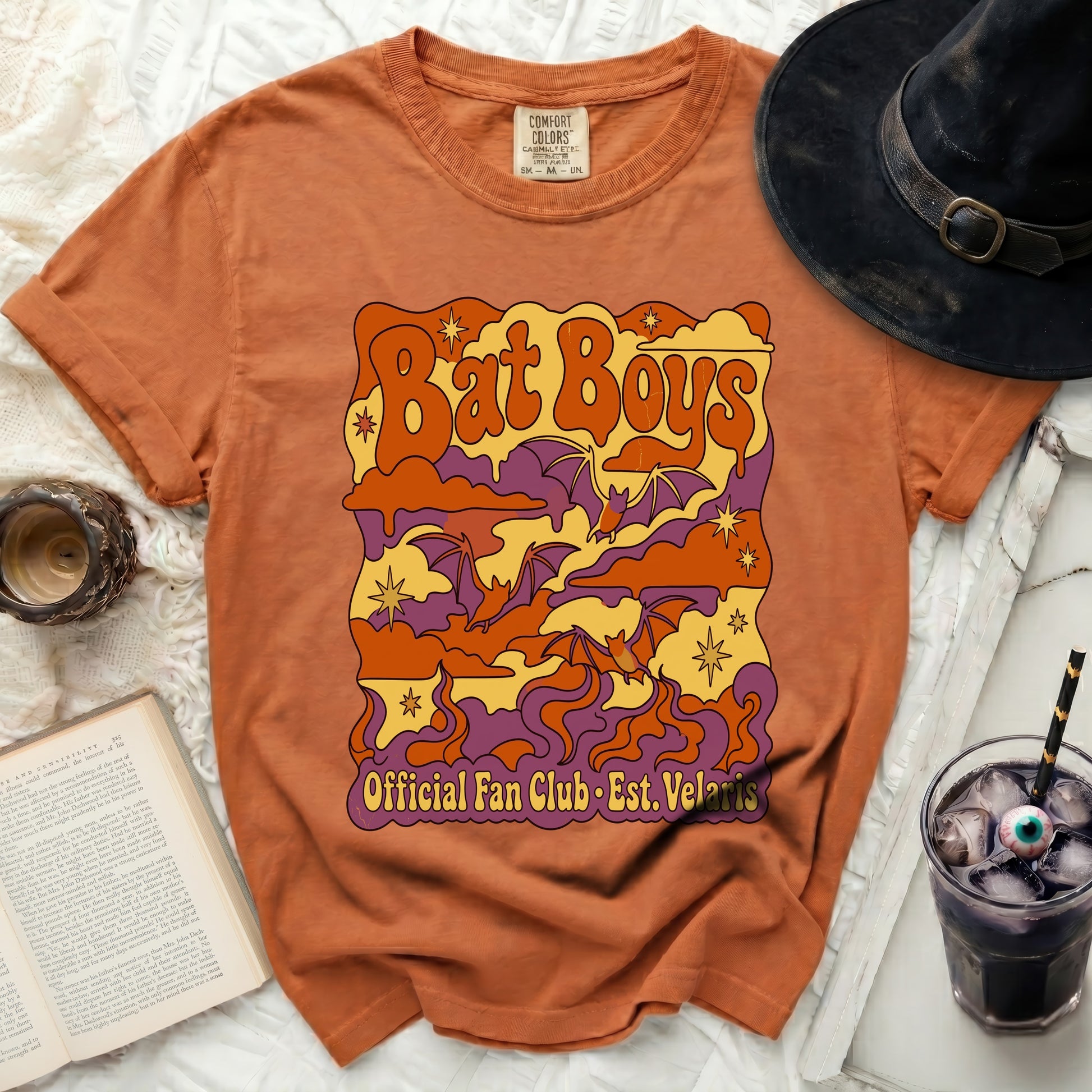 Orange t-shirt with "Bat Boys Official Fan Club Est. Velaris" graphic.
