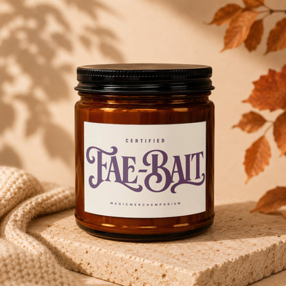Amber jar candle labeled "Fae-Bait" with "Certified MagicMerchemporium" underneath.
