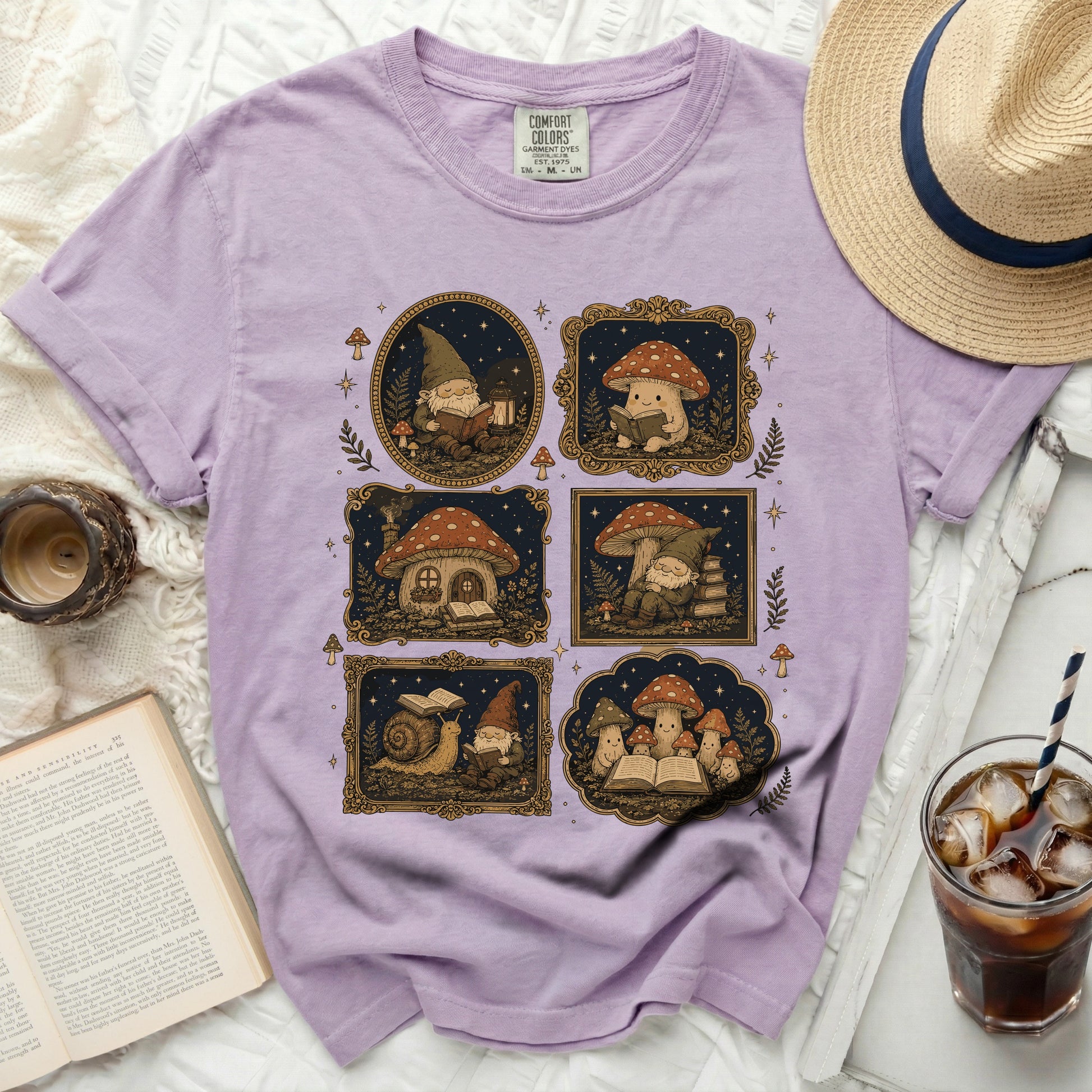 Lavender t-shirt with four framed illustrations of gnomes and mushroom houses.