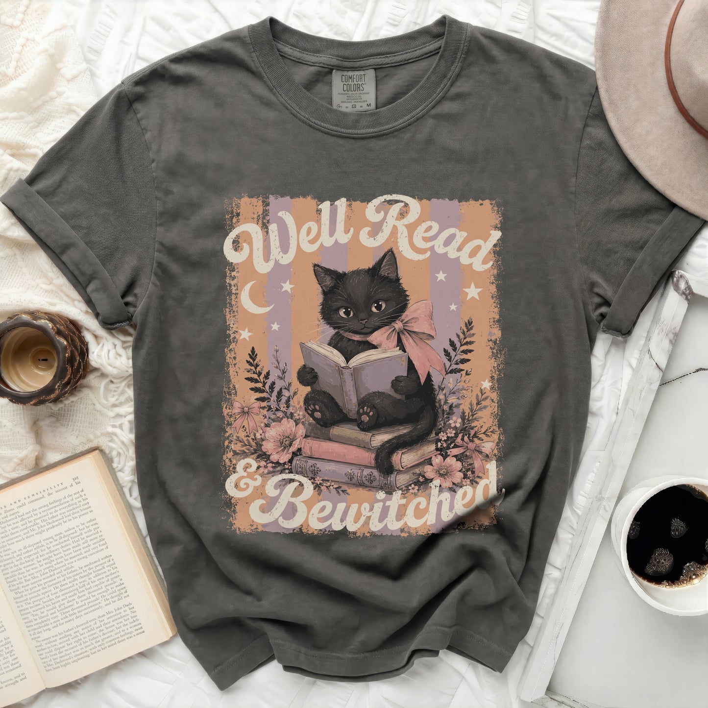 Black cat reading a book with "Well Read & Bewitched" text.