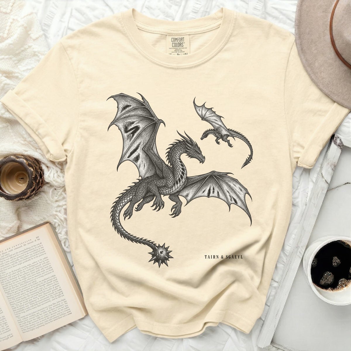 T-shirt with a black ink drawing of two dragons, one large and one small, with text "TAIRN & SGAEYL".