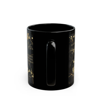 a black cup with gold designs on it