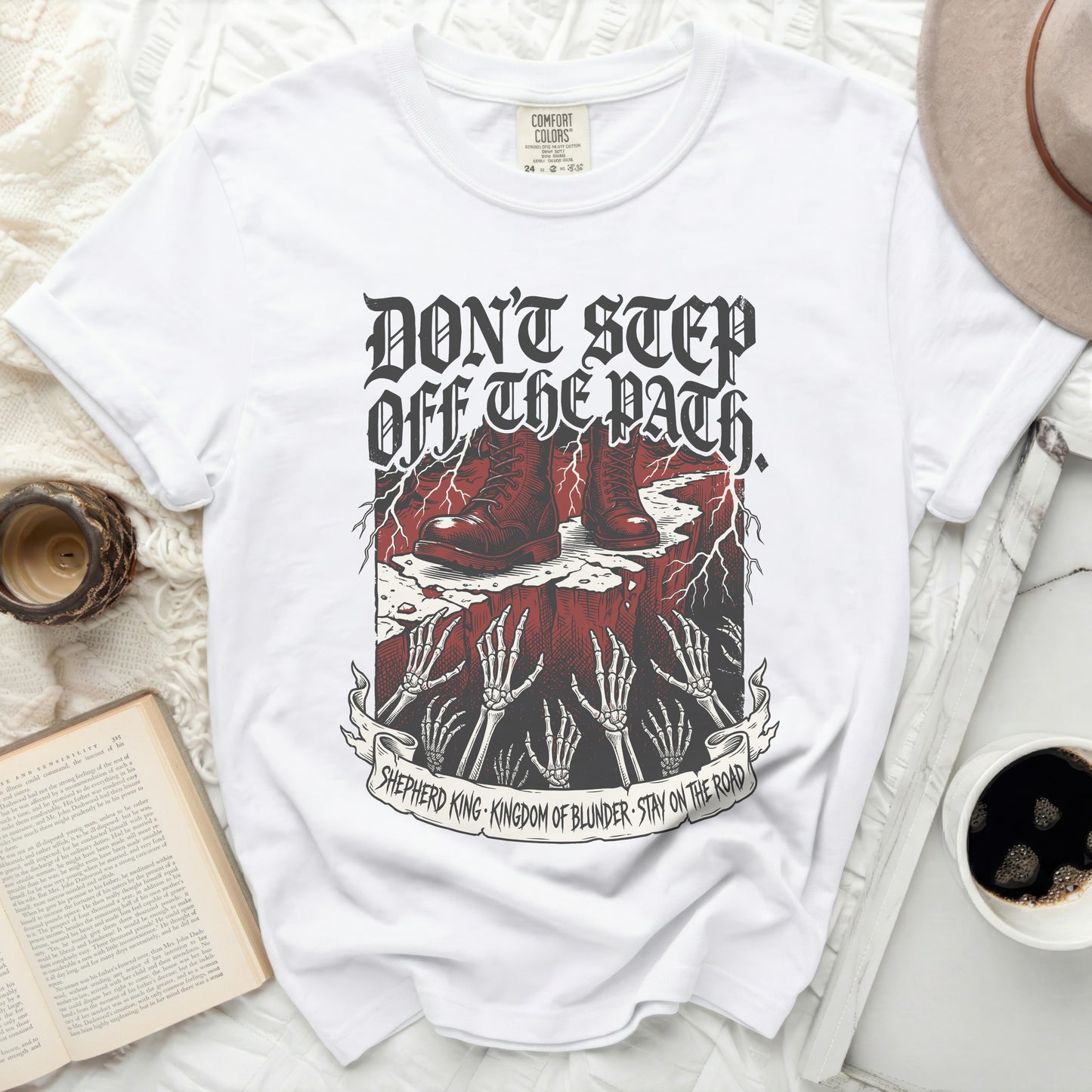 White t-shirt with "Don't Step Off The Path" graphic and text.