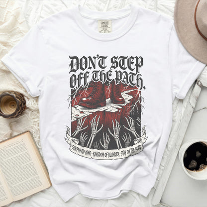 White t-shirt with "Don't Step Off The Path" graphic and text.